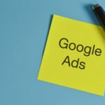 Top view of pen and memo note written with GOOGLE ADS.